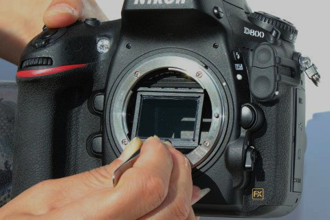 Top tabs of the Nikon VAF filter being guided beneath the reflex mirror